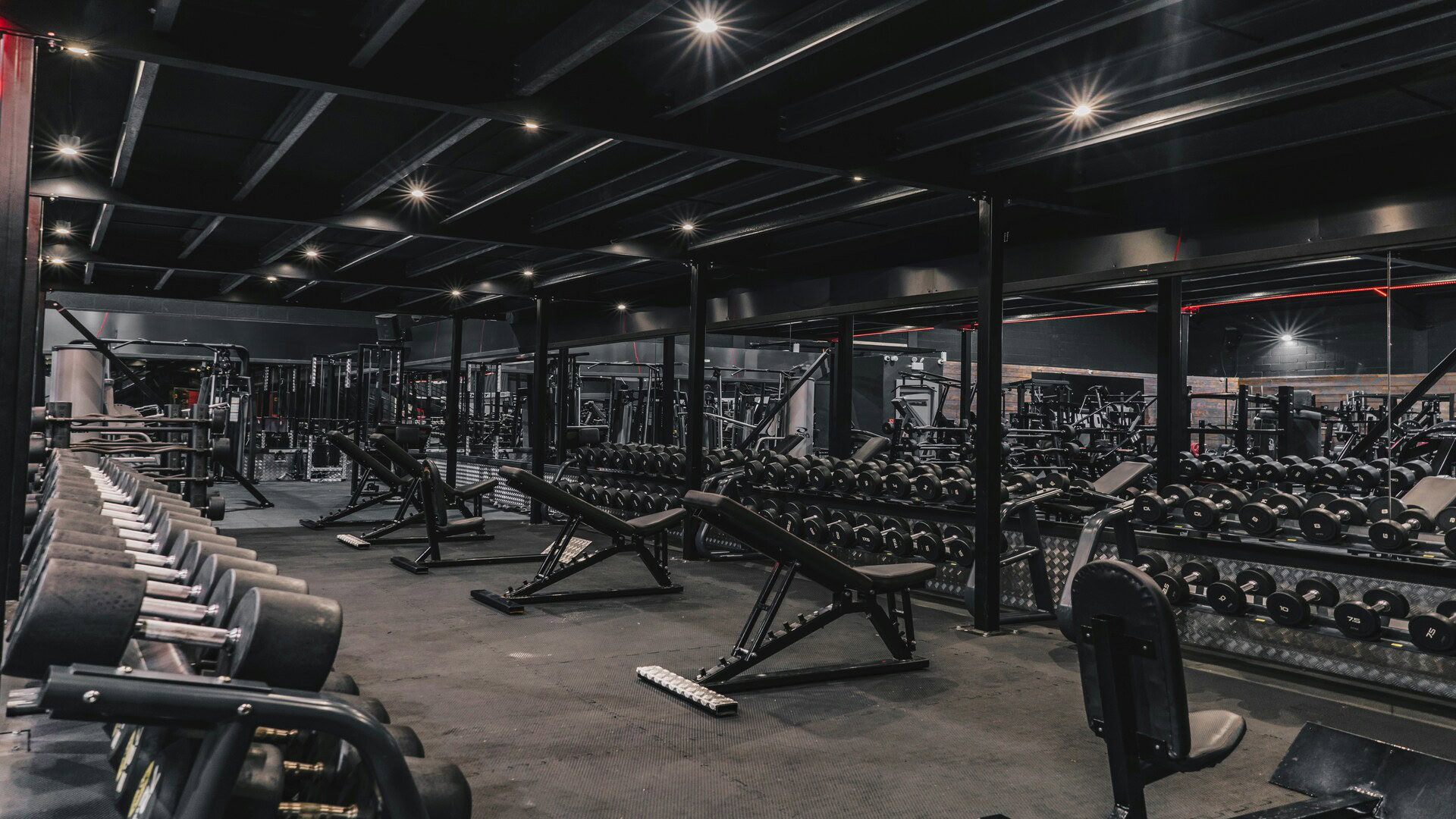 modern industrial gym interior with dumbbells and benches