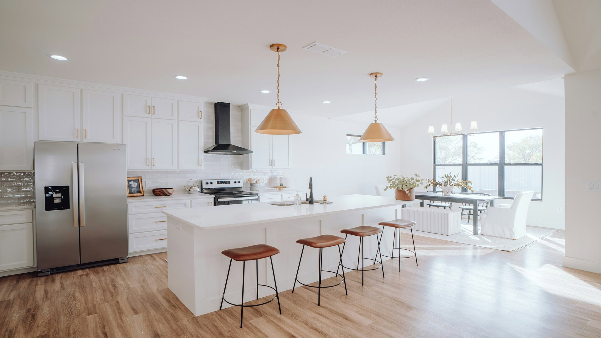 modern white kitchen with dining area