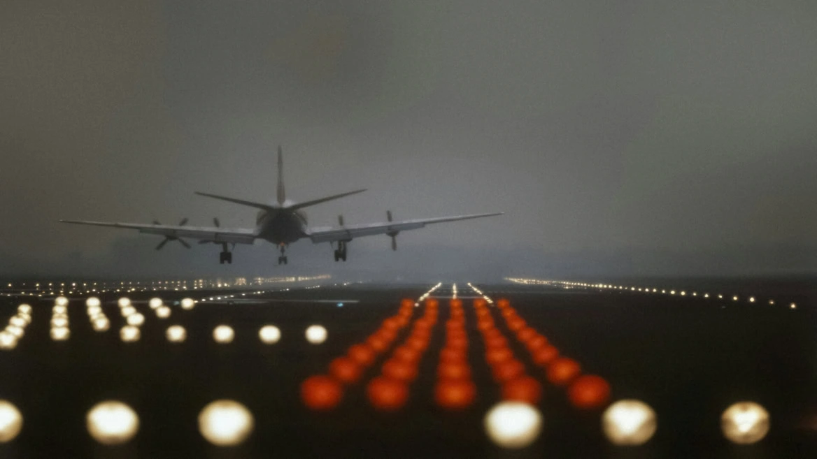 night approach: plane landing through runway lights