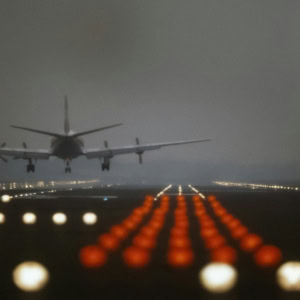 night approach: plane landing through runway lights