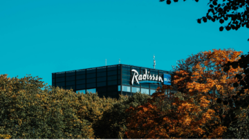 radisson blu hotel über herbstbäumen und blauem himmel