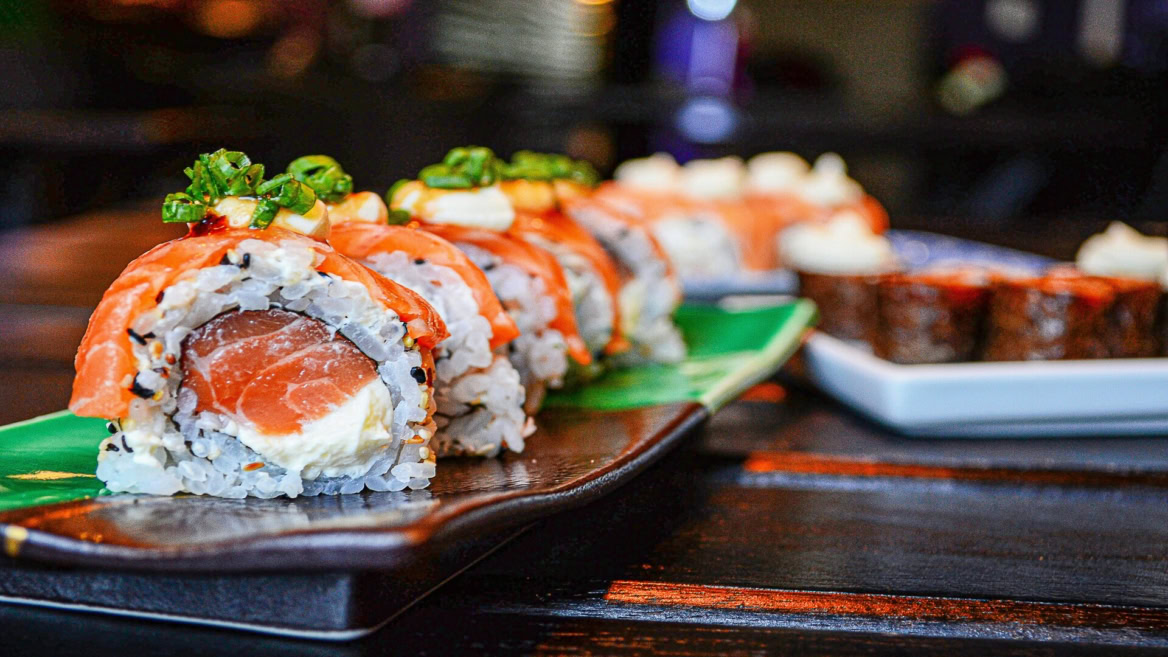salmon sushi roll on dark plate