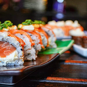 salmon sushi roll on dark plate