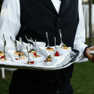 camarero con bandeja de aperitivos en evento exterior