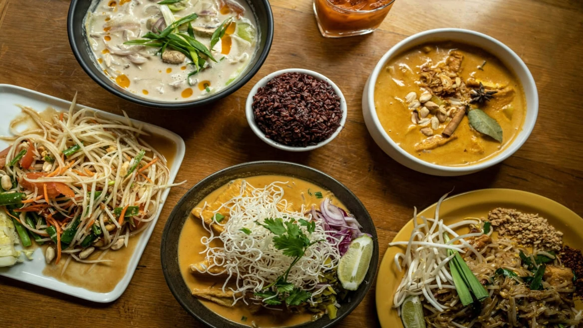 asian feast with curries and noodles
