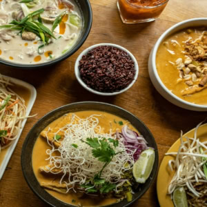 asian feast with curries and noodles