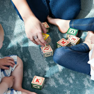 toddler alphabet blocks play on carpet