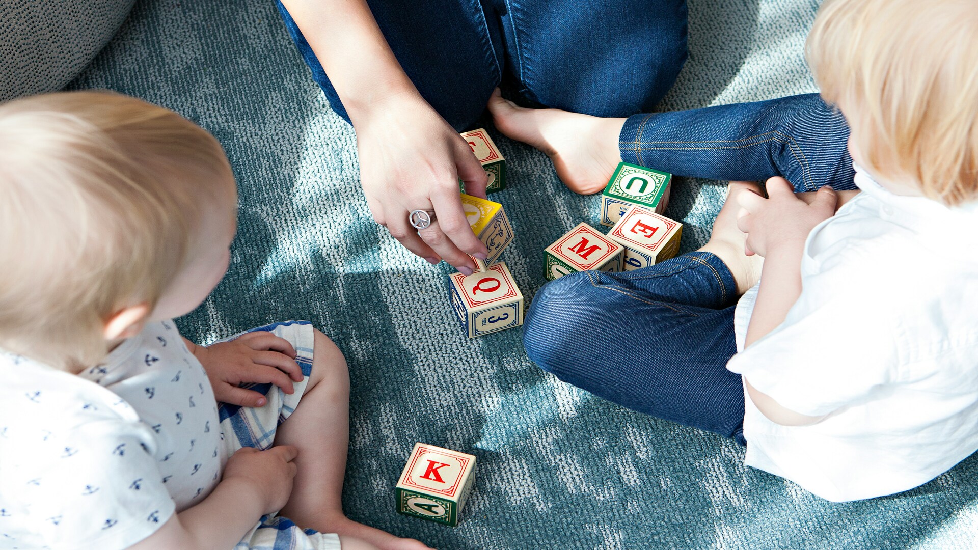 toddler alphabet blocks play on carpet