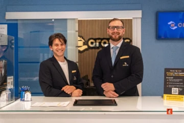 due uomini sorridenti in reception aziendale moderna
