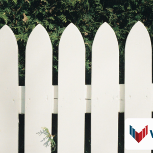 white picket fence with evergreen hedge