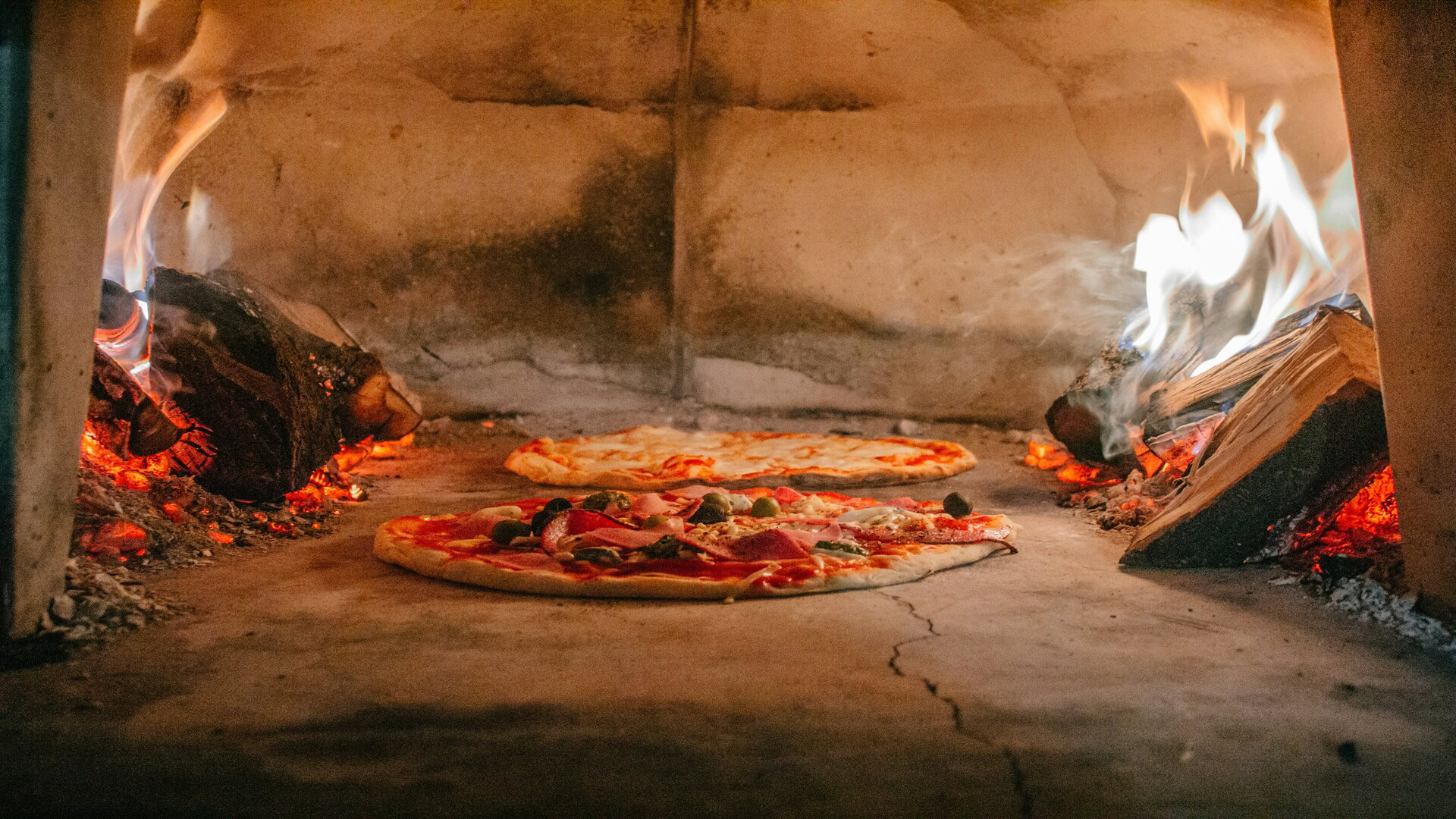 pizza baking in a wood fired oven