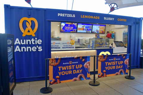 auntie anne’s blue pretzel kiosk with menu boards