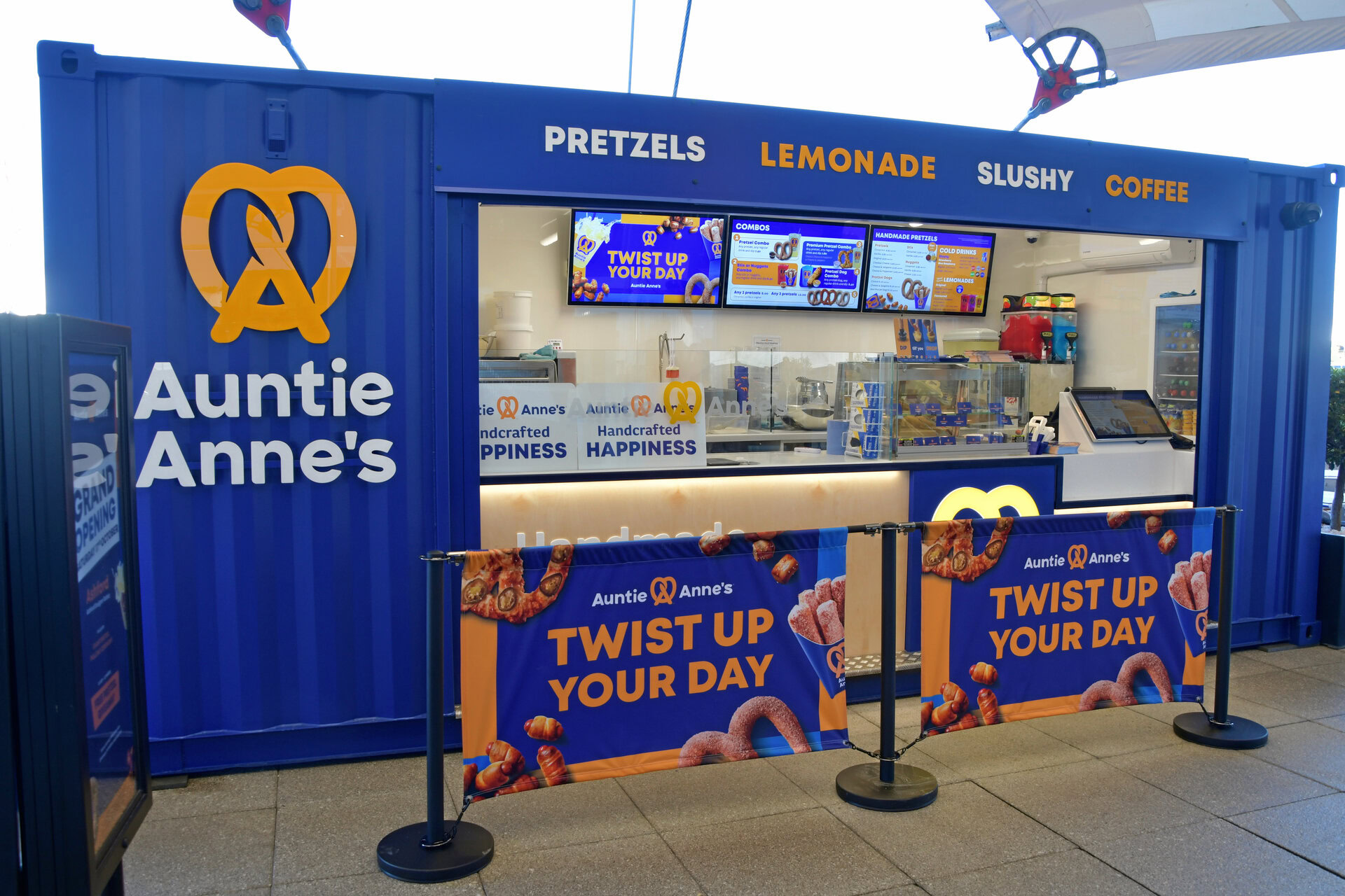 auntie anne’s blue pretzel kiosk with menu boards