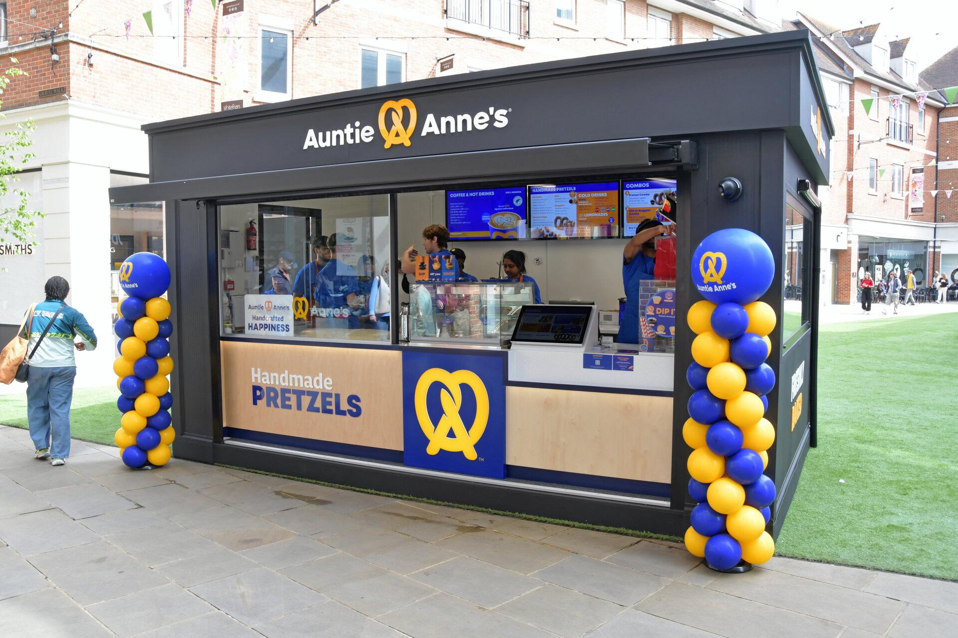 auntie anne’s outdoor pretzel kiosk with balloons