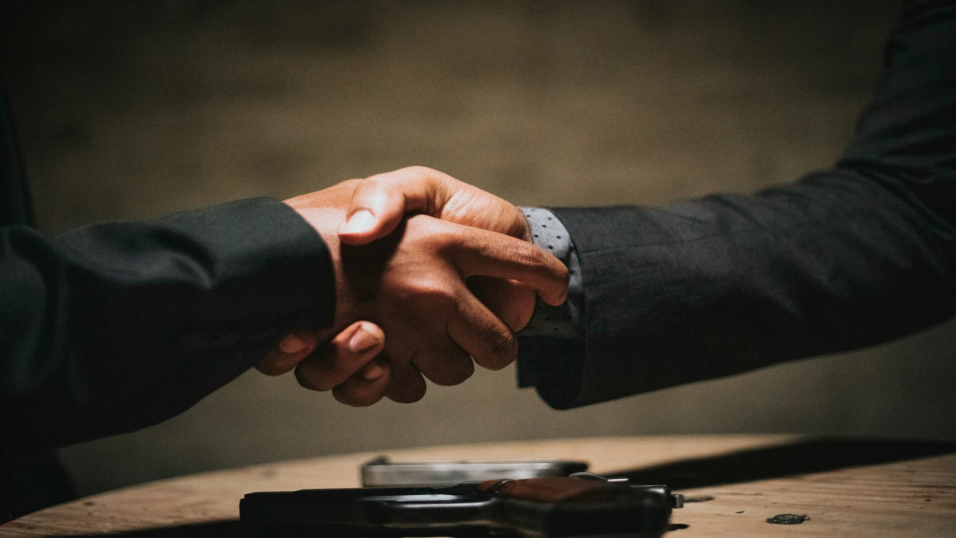 business handshake over a table