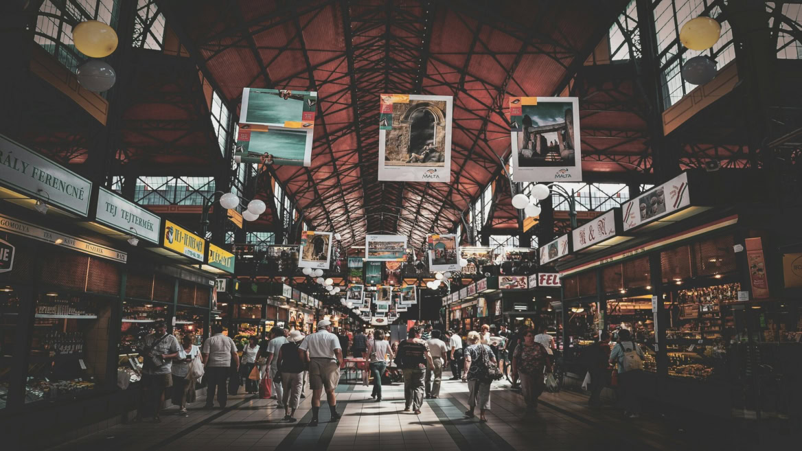 bustling malta market hall under dramatic roof