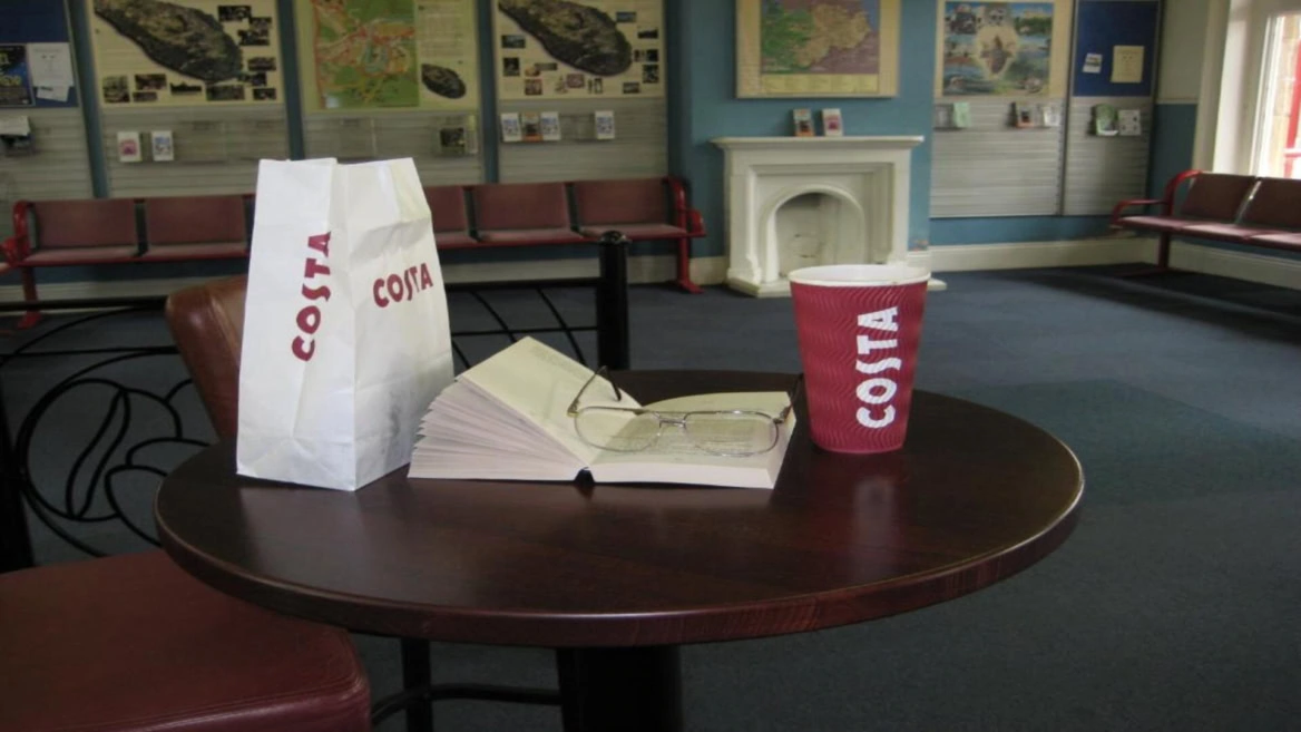 costa coffee table with book in waiting room