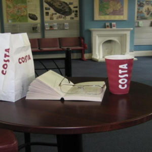 costa coffee table with book in waiting room