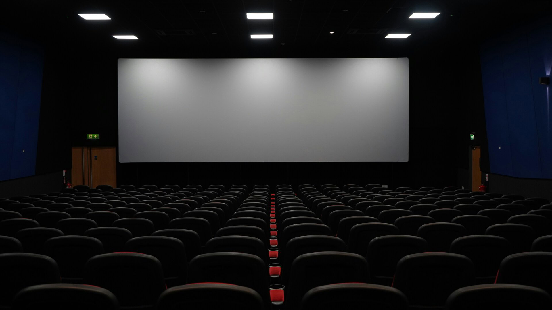 empty modern cinema auditorium with blank screen