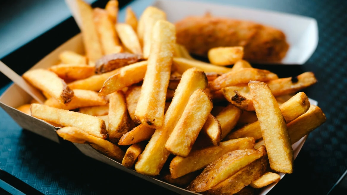 golden crispy fries in cardboard tray