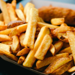 golden crispy fries in cardboard tray