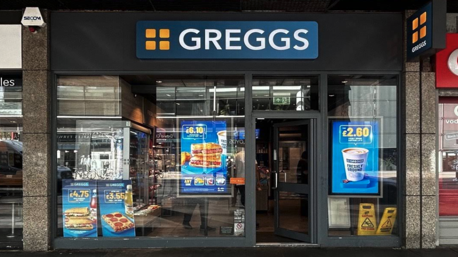 greggs bakery shopfront with blue sign and offers