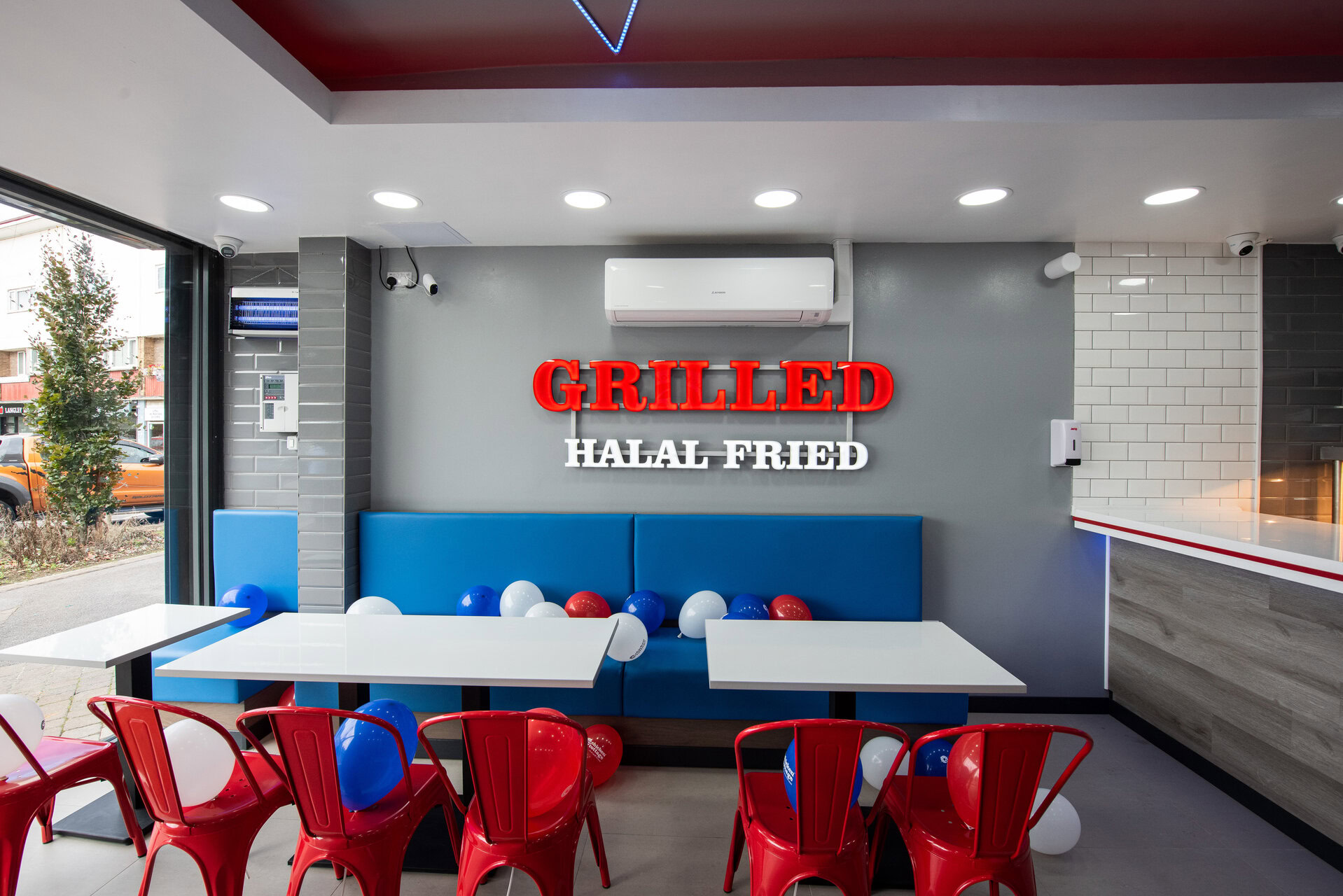 modern halal grill restaurant interior with red chairs