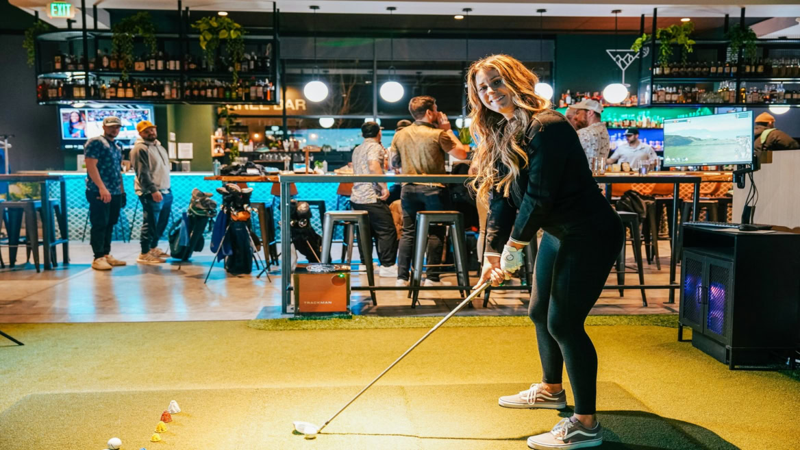 golf practice in a stylish indoor bar