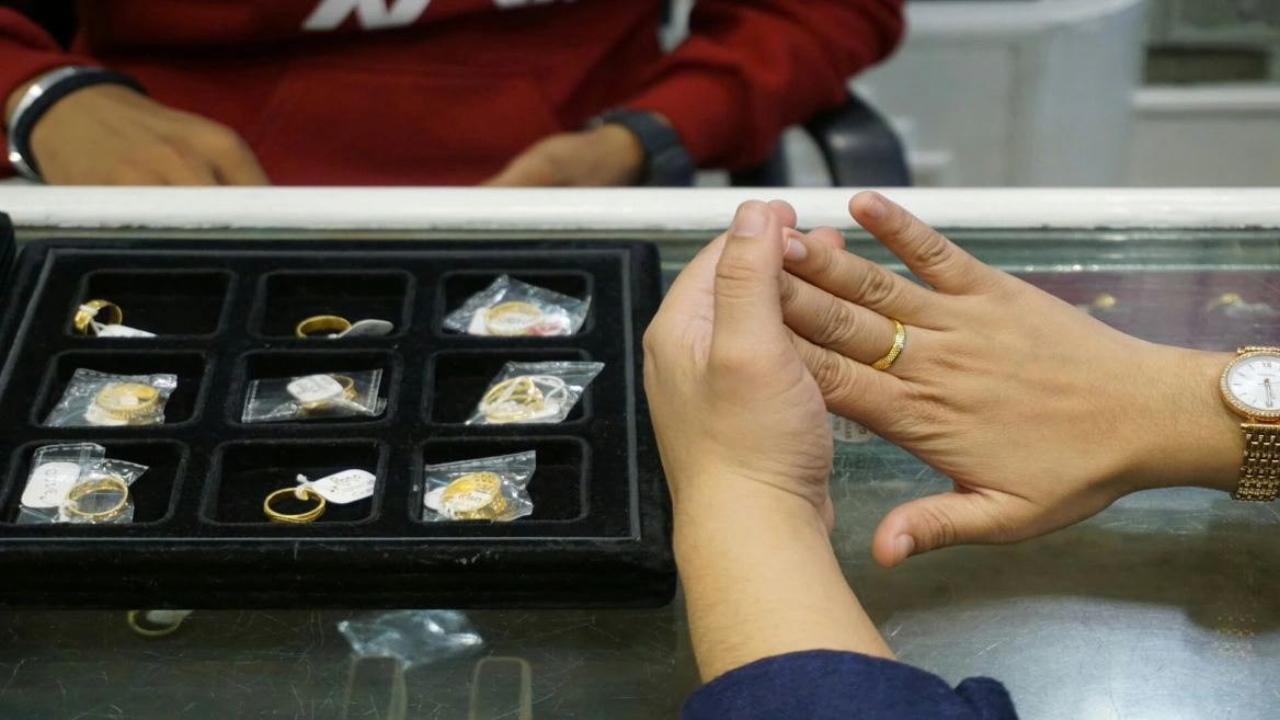 gold ring fitting at jewellery counter