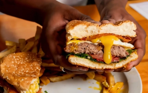 loaded cheeseburger with fries and egg