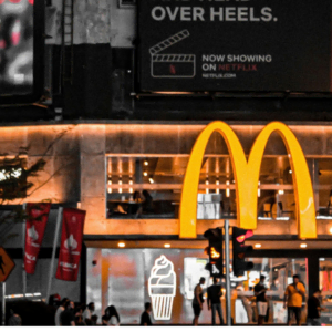 nighttime mcdonald’s with neon city billboards