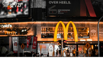 nighttime mcdonald’s with neon city billboards