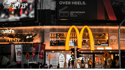 nighttime mcdonald’s with neon city billboards