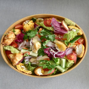 colorful mixed salad in wooden bowl