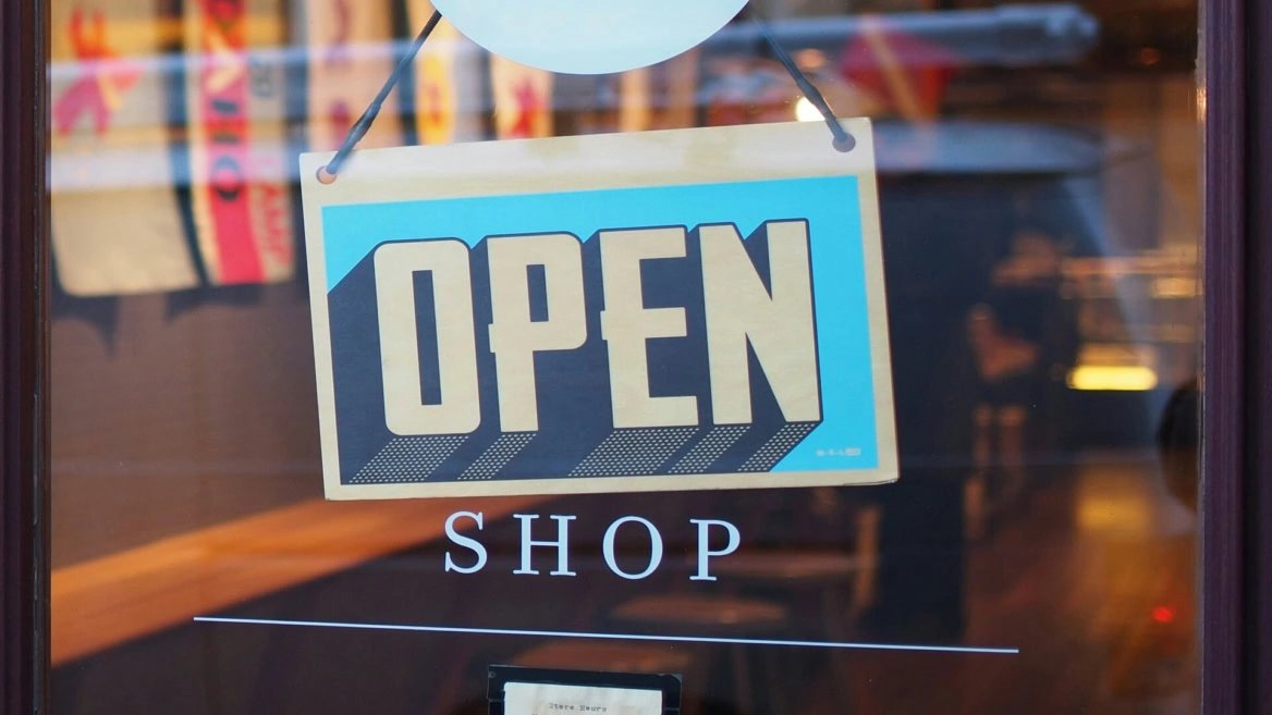 turquoise open sign on shop window