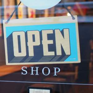 turquoise open sign on shop window