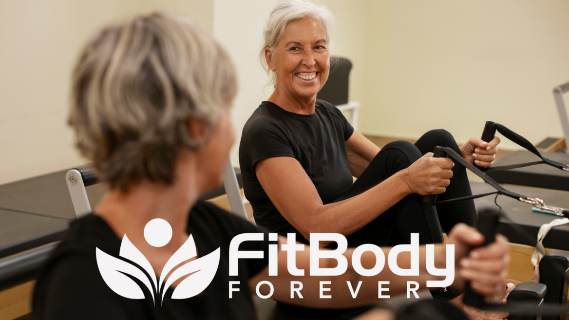 senior pilates reformer class smiling in studio