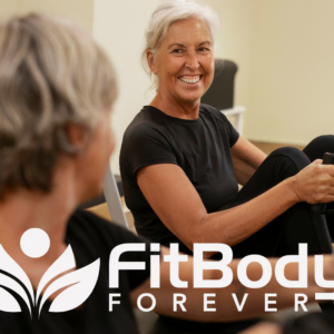 senior pilates reformer class smiling in studio