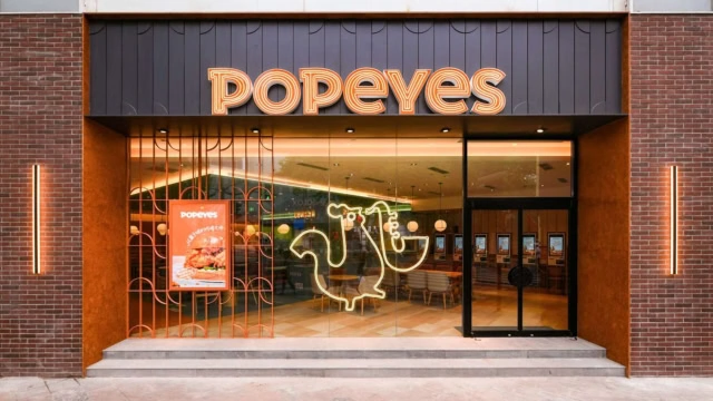 entrée moderne du restaurant popeyes illuminée