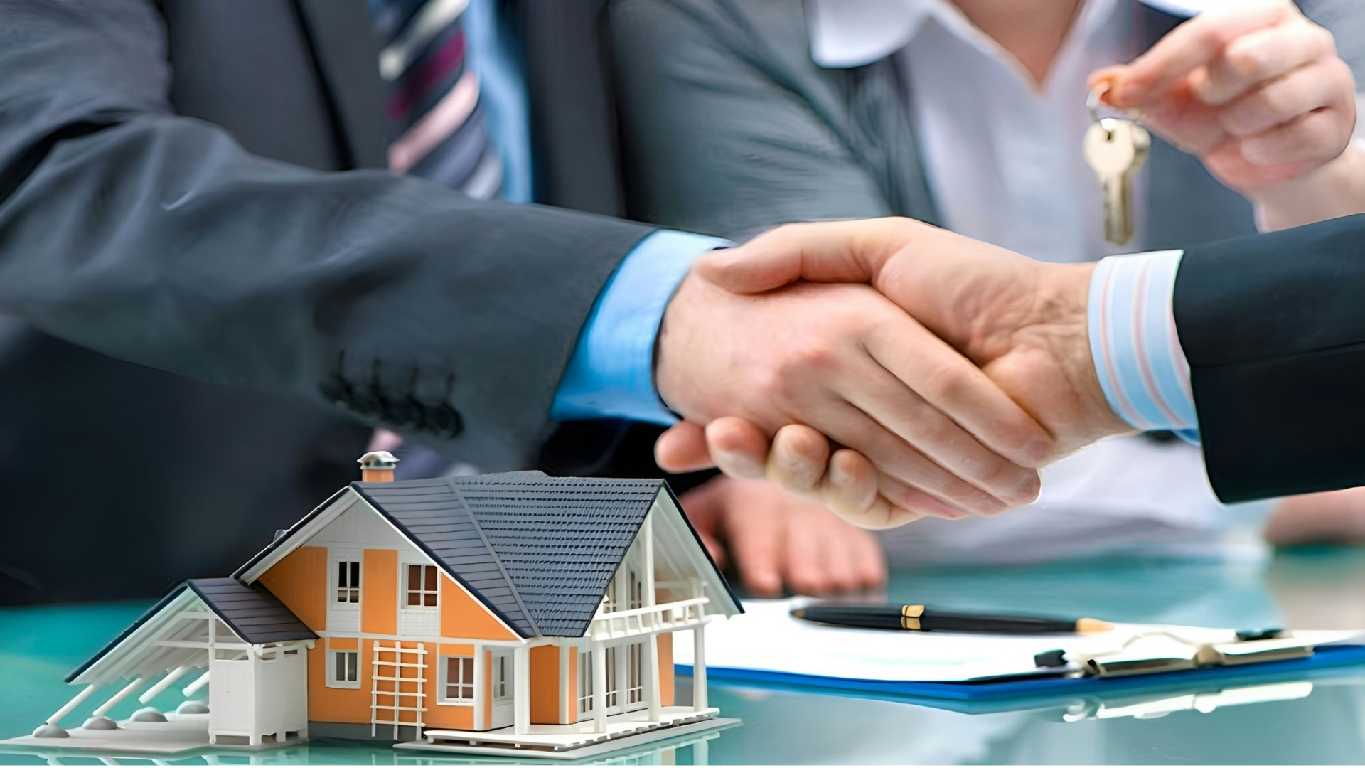 real estate deal handshake with house keys