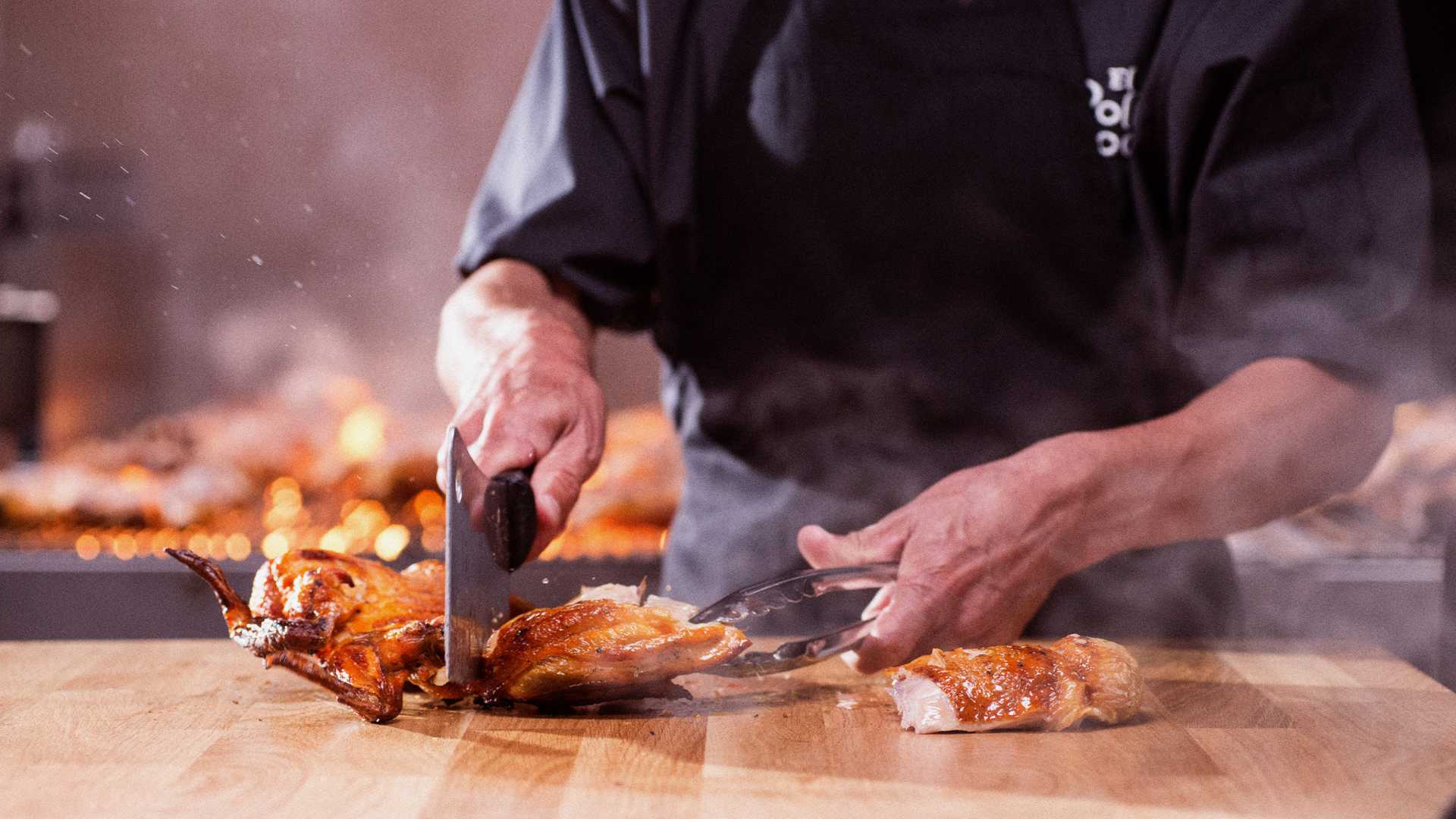 carving roasted chicken on a wooden board