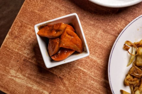 glazed orange vegetables in rustic bowl