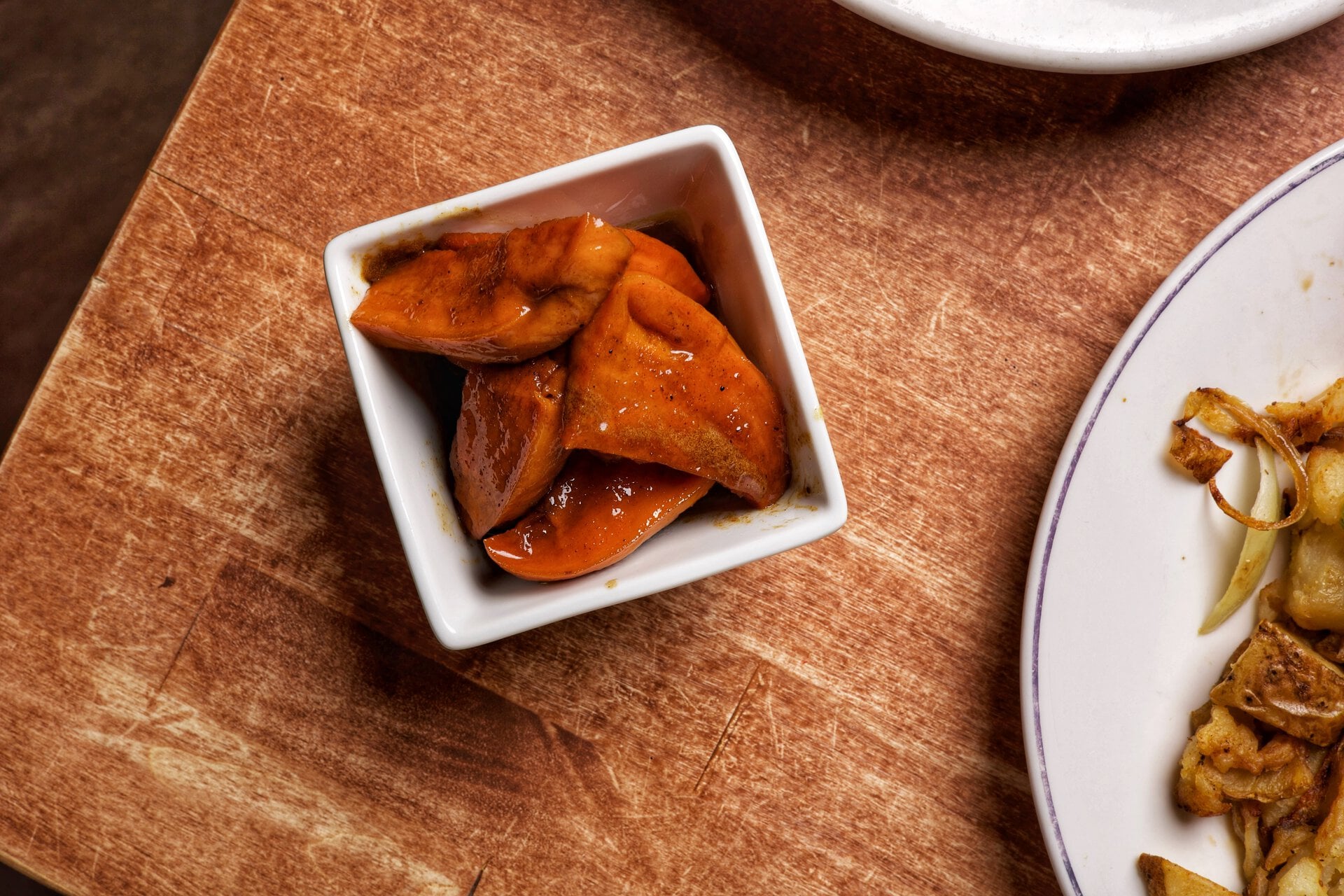 glazed orange vegetables in rustic bowl