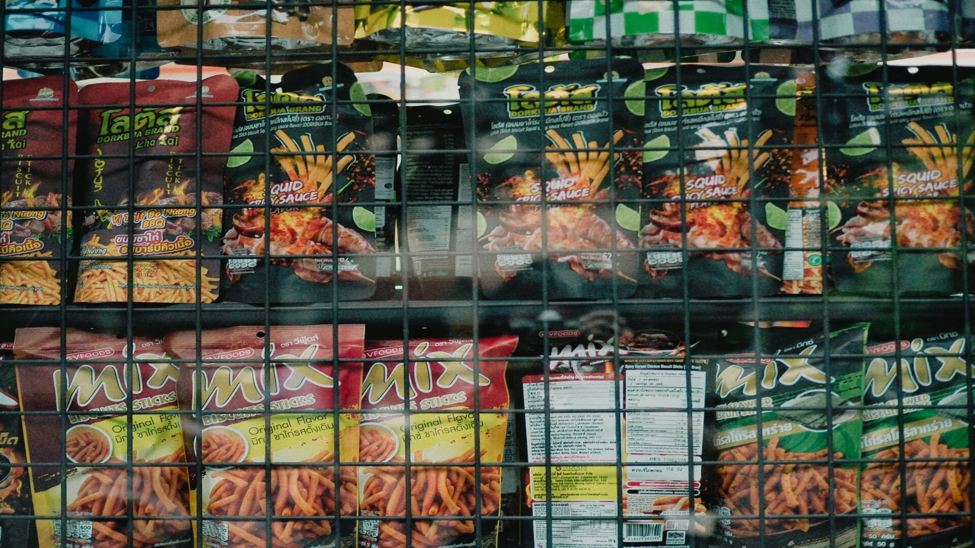colorful snacks behind wire grid display