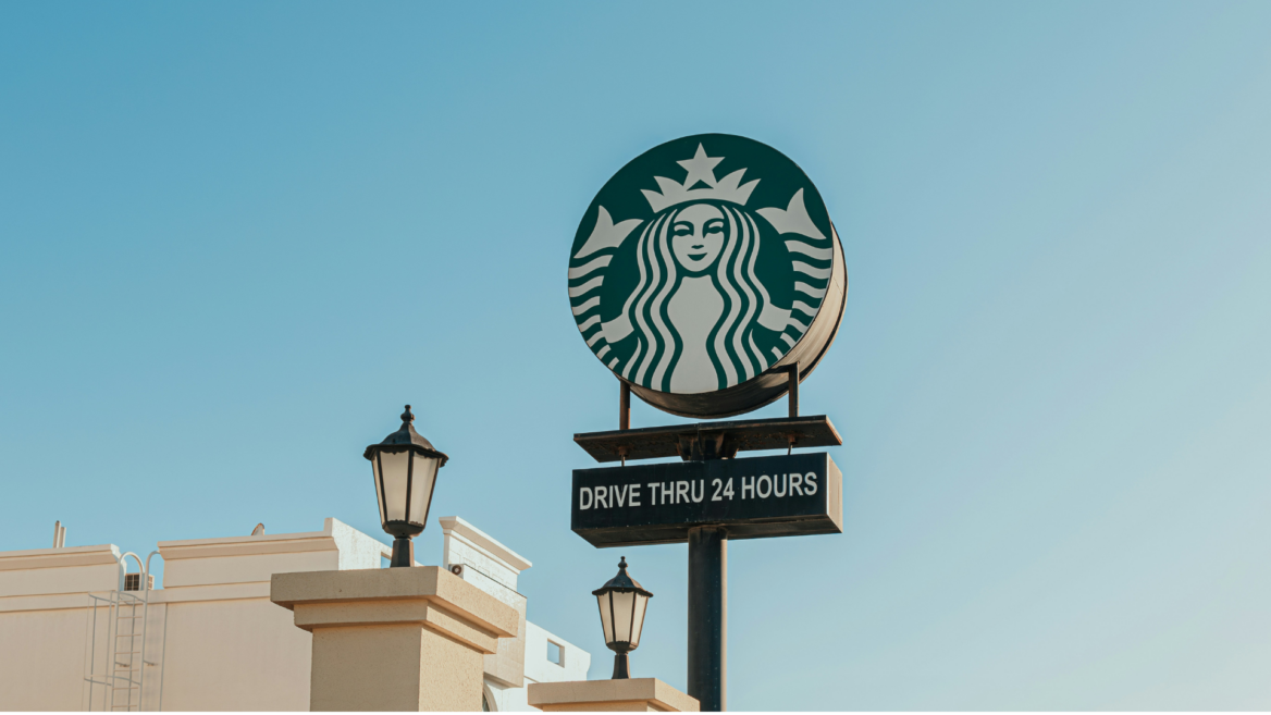 starbucks drive thru 24 hours sign against blue sky