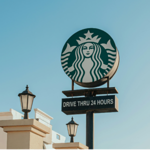 starbucks drive thru 24 hours sign against blue sky