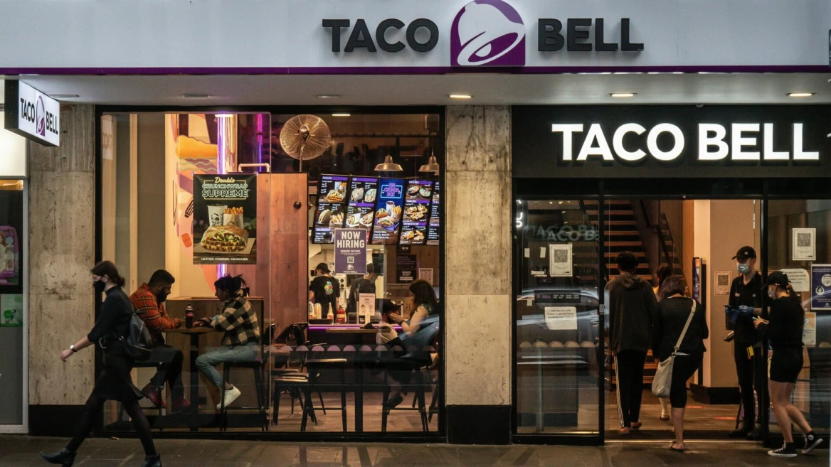 taco bell storefront at night with customers