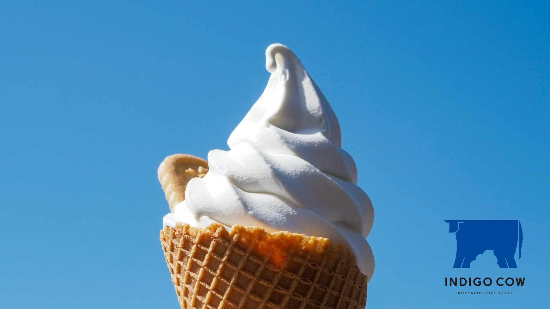 vanilla soft serve cone under blue sky