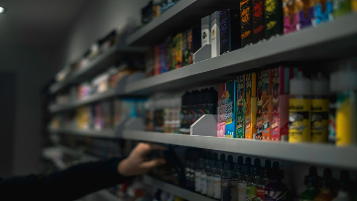 colourful vape products on dim retail shelf