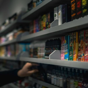 colourful vape products on dim retail shelf